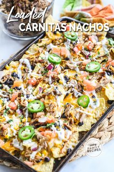 loaded carnitas nachos in a casserole dish