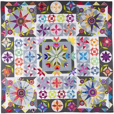 a colorful quilt with many different designs on the front and back, all in various colors