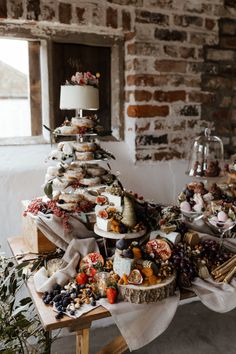 a table topped with lots of different types of cakes and desserts on top of it