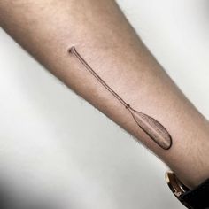 a person's arm with a tattoo on it that has a spoon in it