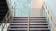 two sets of stairs leading up to the second floor with black and white marble steps