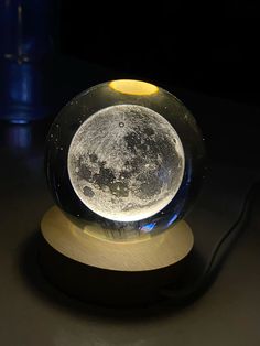 a glass ball with the moon in it