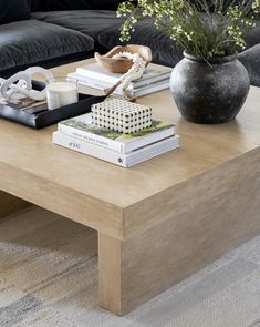 a coffee table with books and flowers on it