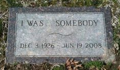 the headstone for i was somebody, which has been placed on the ground in front of