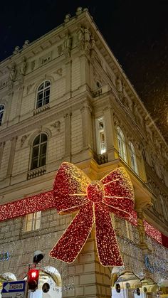 a large red bow hanging from the side of a building