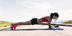 a woman is doing push ups on the ground