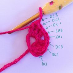 the crochet hook is being used to make an ornament for knitting