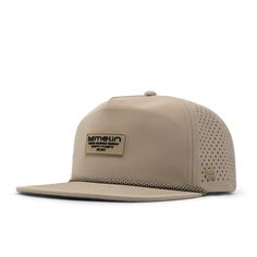 a tan hat with an embroidered patch on the front, and a white visor