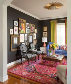 a living room filled with furniture and pictures on the wall