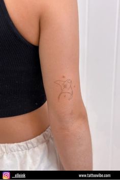 a woman's arm with a small tattoo on the left side of her arm