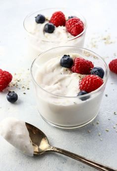 two small bowls filled with yogurt and berries