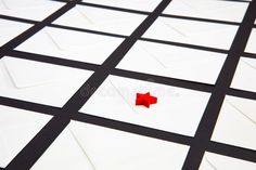 a red piece of paper sitting on top of white squares