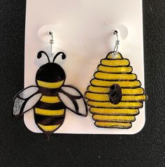 a pair of yellow and black bee earrings