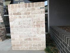 a brick wall next to a building