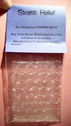 a person is holding up a plastic package with small circles on the inside of it