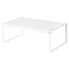 a white table sitting on top of a white floor