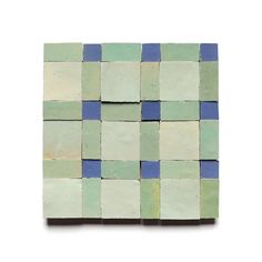 a square tile with blue and green squares on it's sides, against a white background