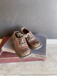 These antique baby shoes are made of brown leather,  well worn The shoes were stuffed with tissue paper at some point and they are marked Size 5:  I would guess them to be for a child of about 2 years old but very narrow These are darling for display  and they show real ingenuity and love. Vintage Brown Low-top Oxfords, Vintage Brown Leather Shoes With Plain Toe, Vintage Brown Leather Slip-on Shoes, Vintage Brown Oxfords With Leather Sole, Vintage Leather Shoes With Rubber Sole, Vintage Lace-up Leather Shoes, Vintage Closed Toe Oxfords With Rubber Sole, Vintage Low-top Oxfords With Rubber Sole, Vintage Plain Toe Leather Shoes