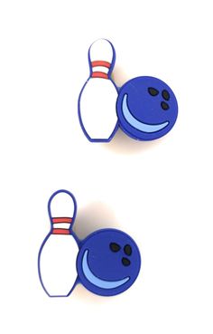 two blue bowling pins with faces drawn on them, one has a bowling ball and the other has a bowling pin