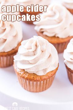 cupcakes with white frosting on top and the words apple cider cupcakes above them