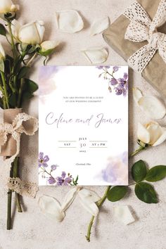 a wedding card with flowers and ribbon on the table next to some gift wrappings