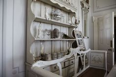 an old china cabinet is decorated in white