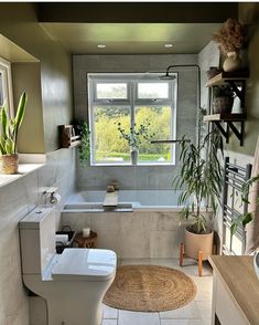 a bathroom with a tub, toilet and sink in it's center area is shown