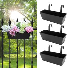 three black metal planters with flowers in them