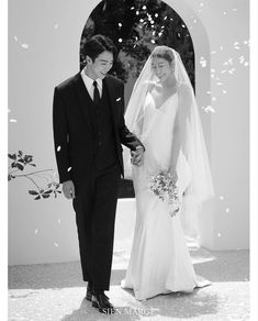 a bride and groom walking down the aisle with confetti falling all around them