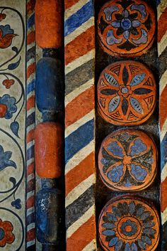 four orange and blue decorative objects on display