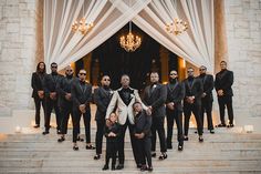 a group of men in suits standing on steps