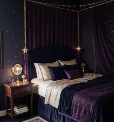 a bed with purple and gold decor in a dark colored room, along with a night stand