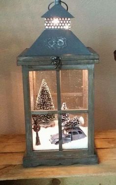 a small lantern with a christmas tree in it