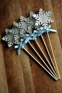 four silver snowflake picks with blue ribbons