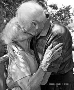 an older couple embracing each other in black and white