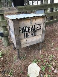 a wooden box with the words packages he're written on it in front of a fence