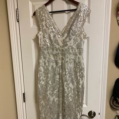 a white dress hanging up on a door