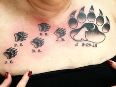 a woman's chest with an animal paw tattoo on it