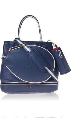 a blue handbag with white trims on the handles and shoulder strap, sitting in front of a white background