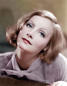 an old black and white photo of a woman wearing a bow tie looking off to the side