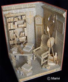 a paper model of a room with furniture and books