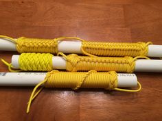 three yellow and white curlings sitting on top of a wooden table next to each other