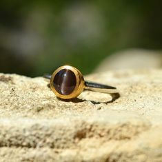 Cat's Eye Chrysoberyl Ring, Solitaire Ring, Bohemian Gemstone Ring, Round Statement Ring, Anniversary Ring, Unique Ring, Gift For Her Please select size and metal from the drop down menu. ⚜️Weight: 2.1gr   💎Gemstone: Chrysoberyl Cat's Eye 0.90cm Gold gemstone ring that can be combined are the coolest accessory now.This is the place for ultimate ear styling. Striking and affordable. Make your own Ear Story! Wrap your ears in cuffs you'll love.  🦚 Visit my gemstone rings collection:  https://www.etsy.com/shop/noahconcept/?etsrc=sdt&fbclid=PAAabX3la4ZzrGRug-fdx0AVTcM8lpjsQHSMDfEzyRu4du-woM_ISVKRQy-x4_aem_AX0rENIVkOuE6tb8lFnkZ-I7L1xhLyAzS9jU5bKkczHscuq2Zk93UMLbmGnlinC5MBA&section_id=43942909 The jewelry you buy from NoahConcept are delivered in ♻️ eco friendly boxes with the brand name on th Round Cabochon Sapphire Ring For Gift, Round Cabochon Sapphire Ring, Brown Handmade Rings For Anniversary, Handmade Brown Rings For Anniversary, Ear Styling, Rings Collection, Artisan Rings, Gold Gemstone Ring, Unique Ring