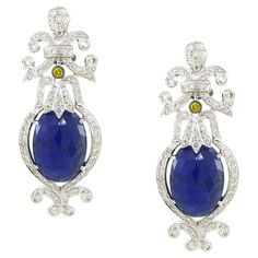 Indulge in the enchanting allure of our Tanzanite Chandelier Earrings, a harmonious blend of sophistication and splendor. Nestled at the core of each earring is a mesmerizing Tanzanite gemstone, boasting a substantial weight of 16.45 carats, radiating an ethereal violet-blue hue that captures the imagination. Surrounding this captivating centerpiece are delicate white round diamonds, totaling 1.98 carats, creating a luminous halo that accentuates the Tanzanite's natural brilliance. Inspired by t Gala Event, Tanzanite Earrings, Gala Events, Tanzanite Gemstone, Formal Gown, Dream Jewelry, Blue Hues, Chandelier Earrings, Tanzania