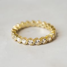 a yellow gold ring with small white stones