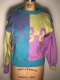 Hand made item from the 80’s with a tag still attached. This is a hand made sweater. There are no tags other than the one attached Tag size 6Measurements laying flat 16” pit to pit 20” length 90s Style Purple Sweater For Fall, 90s Style Purple Fall Sweater, Retro Knitted Acrylic Sweater, 90s Purple Winter Sweater, Retro Multicolor Acrylic Sweater, Vintage Hand Knitted Crew Neck Sweater, Vintage Multicolor Knitted Sweater, Retro Purple Sweater For Winter, Vintage Multicolor Acrylic Sweater