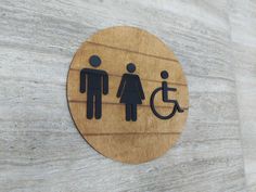 a wooden sign on the side of a building that says people with a wheel chair