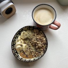 a bowl of food and a cup of coffee on a table