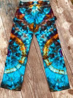 a pair of blue and yellow tie dye pants with the words gold trouse browns on it