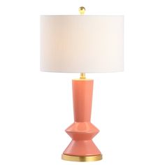 an orange table lamp with a white shade on the top and gold trim around the base